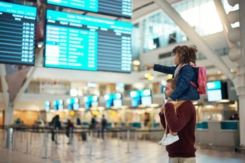 Airport, travel and father with his child on his shoulders reading the schedule Stock Photos
