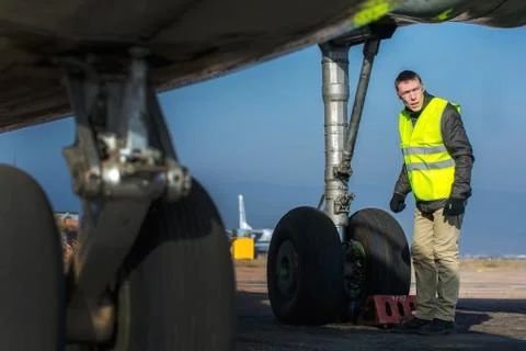 Airport worker checking chassis Stock Photos