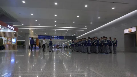 Airport workers stand in a row in almost empty airport in Hong Kong, China 動画素材 144817948