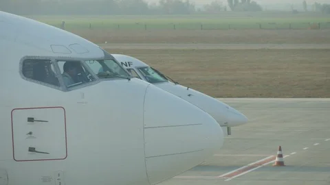 Airport workers in uniform regulating several airplanes in an airport in spring Vídeo Stock 107908645