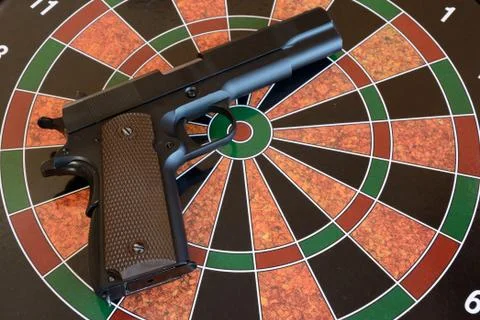 Airsoft gun on target - dartboard Stock Photos