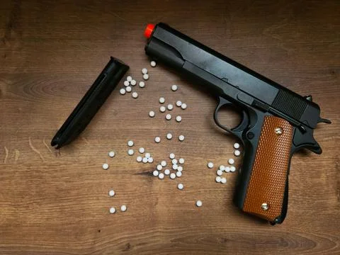 Airsoft gun with white bullets Stock Photos