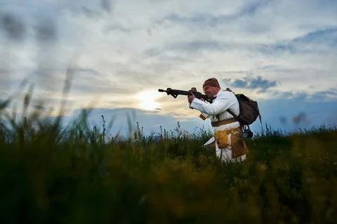 Airsoft player in a doctor's suit with a machine gun in his hands Stock Photos
