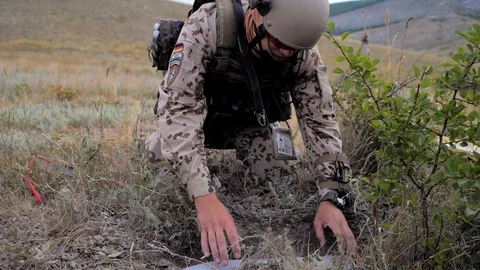 Airsoft. The sapper finished his work. takes the projectile out of the pit Stock Footage 129327746