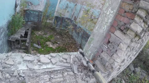 Airsofter with automatic rifle climbs out the window. First-person view Video stock 68517586