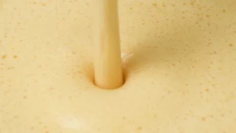 Airy light batter for baking pour macro slow motion Stock Footage 325109150