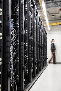 An aisle of racks in a computer server farm. Stock Photos
