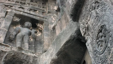 Ajanta caves, India. Low angle view of hand carved Jainism deity. 스톡 동영상 117343595