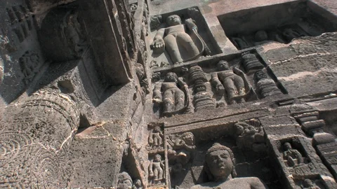 Ajanta caves, India. Low angle view of hand carved series of Jainist deities. Video stock 117344115