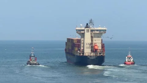 Ajman, UAE - 19 April 2026: Tugboats assist MSC Houston V container ship during Stock Footage 345035475