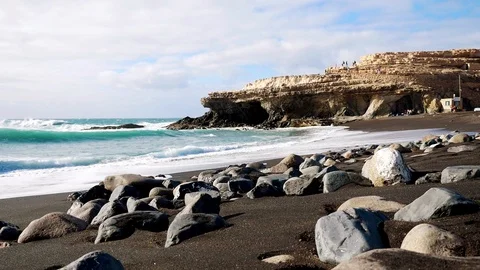 Ajuy, black sand at the beach, cliffs and caves on a sunny day, Fuerteventura Stock Footage 103275247