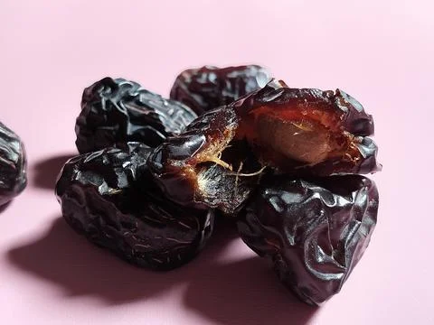 Ajwa dates on a pink background. 写真素材