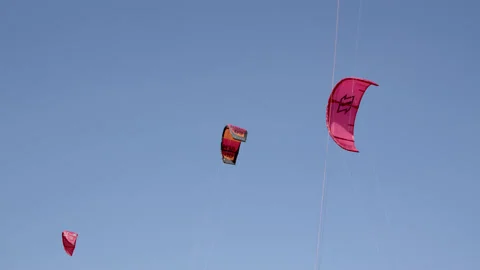 Akyaka, Turkey - CIRCA 2022: red color kitesurfer parachutes close-up against Stock Footage 222867592