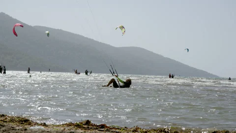Akyaka, Turkey - CIRCA 2022: undefined man start kitesurfing in Akyaka of Stock Footage 222871397