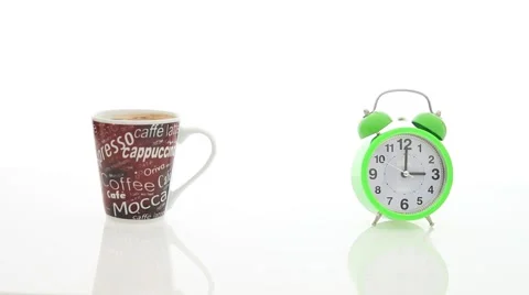 Alarm clock and cup on table Stock Footage 67646357