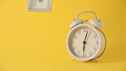 Alarm clock and falling dollars on yellow background. Time money concept 스톡 동영상 141358452