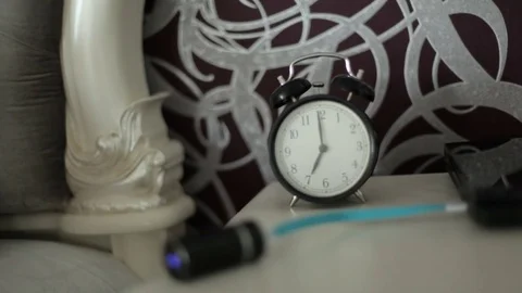 Alarm clock and gadgets on the table Stock Footage 77580243