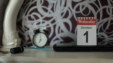 Alarm clock and gadgets on the table Stock Footage 77580377