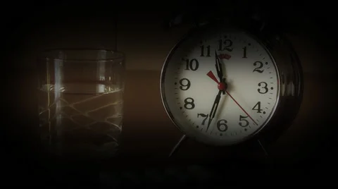 Alarm Clock and Pills on the table, taking pills on schedule Stock Footage 47292418