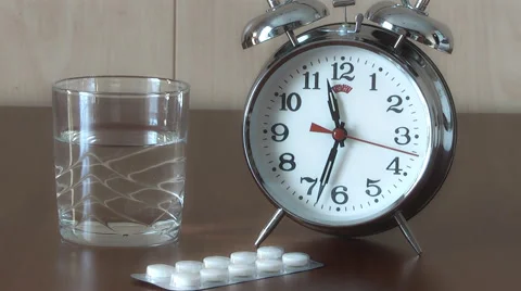 Alarm Clock and Pills on the table, taking pills on schedule Stock Footage 47292480