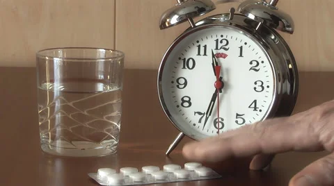 Alarm Clock and Pills on the table, taking pills on schedule Stock Footage 47292520