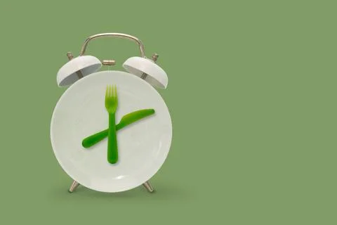 Alarm clock and plate with fork and knife Foto stock