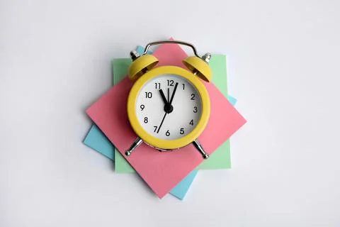 Alarm clock and reminder notes on light grey background, top view Stock Photos