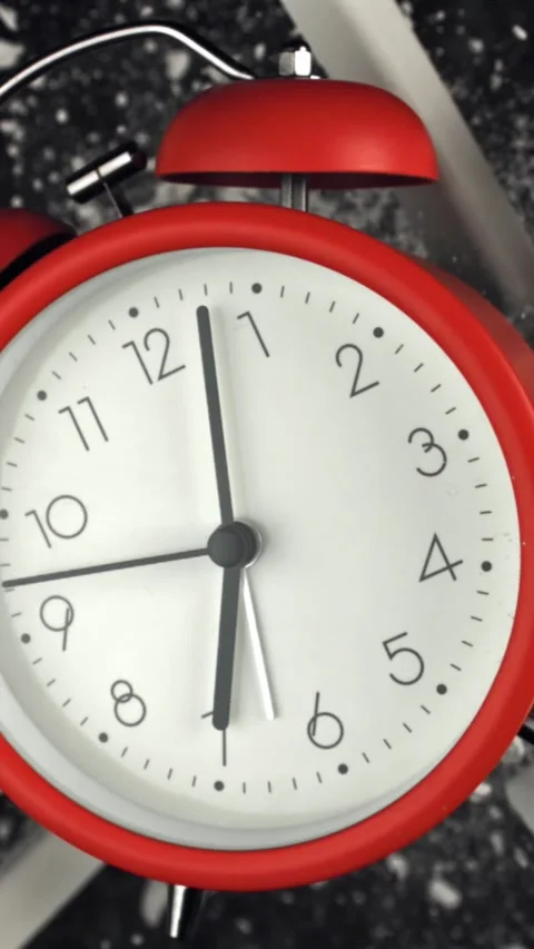 Alarm clock and school crayons fly up on a black background. Filmed on a high Stock Footage 335381070