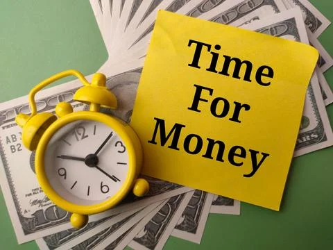Alarm clock and sticky note with the word Time For Money on a green backgroun 写真素材