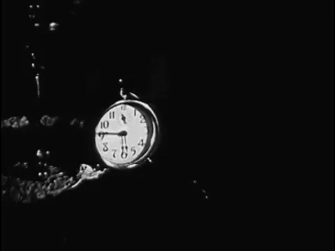 An alarm clock awakens a draftee who reads his orders, dresses and departs for Vídeos de archivo 74947513