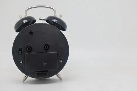 Alarm clock back view, reverse side of time, dark side of time. Stock Photos