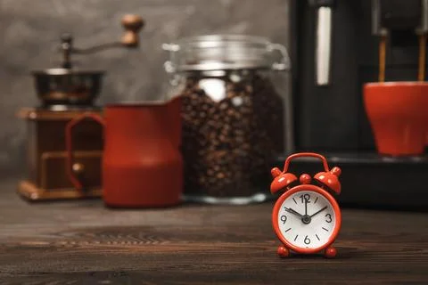 Alarm clock on the background of the coffee machine Stock Photos