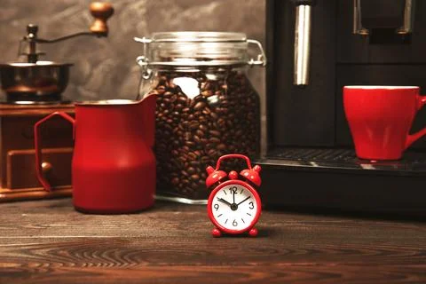 Alarm clock on the background of the coffee machine Stock Photos