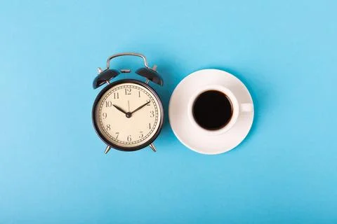 Alarm clock on the background of the coffee machine Stock Photos
