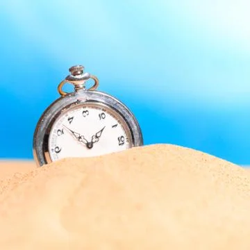 Alarm clock on the beach Stock Photos