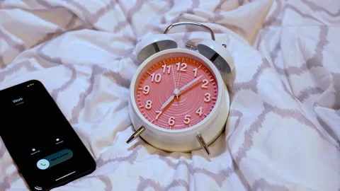 Alarm clock on the bed and incoming call from work Stock Footage 150283348