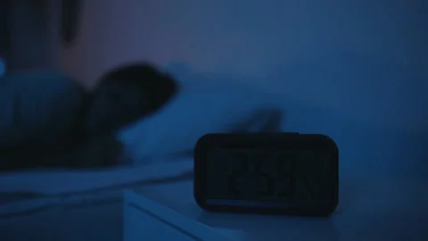 Alarm clock by the bed at night close up Stock Footage 158765394