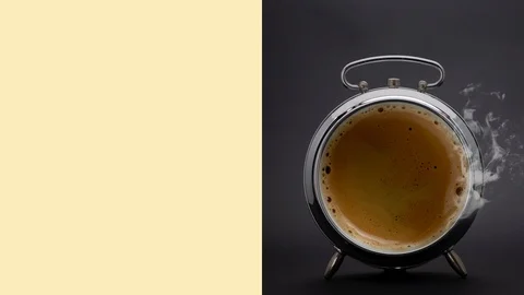 An alarm clock on a black background containing coffee Stock Footage 125533149