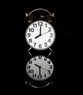 Alarm clock before black Stock Photos