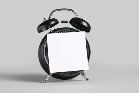 Alarm clock with blank sticky note on grey background. Time management concep Stock Photos