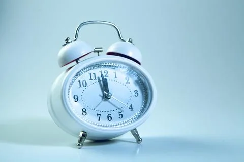 Alarm clock on blue background with copy space. Time concept. Stock Photos