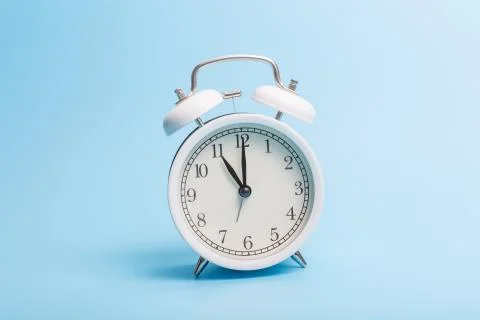Alarm clock on blue background Stock Photos
