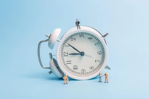 Alarm clock on blue background Stock Photos