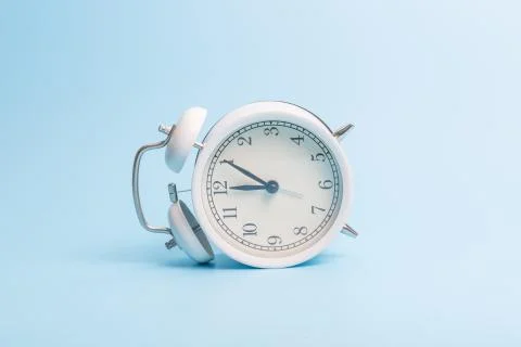 Alarm clock on blue background Stock Photos