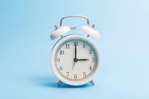 Alarm clock on blue background Stock Photos