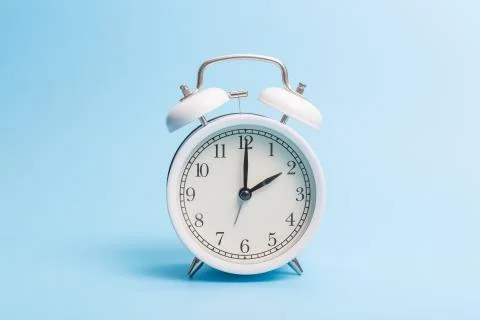 Alarm clock on blue background Stock Photos