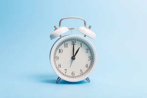 Alarm clock on blue background Stock Photos