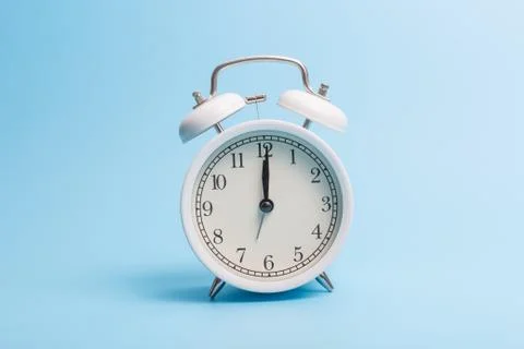 Alarm clock on blue background Stock Photos
