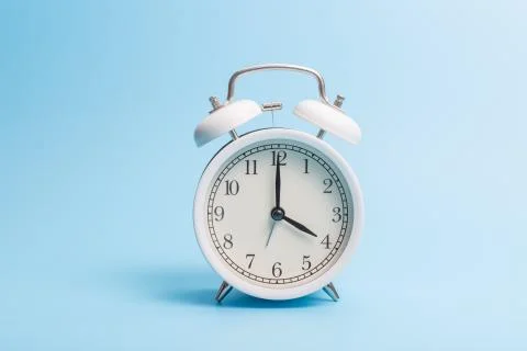 Alarm clock on blue background Stock Photos