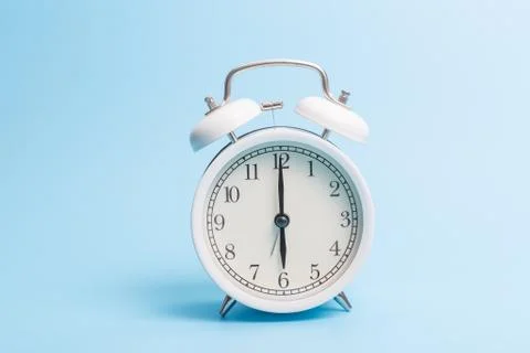 Alarm clock on blue background Stock Photos